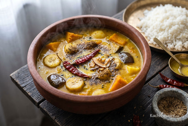 Dalma, a thick golden-yellow dal with visible chunks of orange pumpkin half dissolved