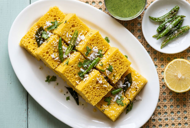 Yellow khaman squares topped with grated coconut and coriander, served with green chutney