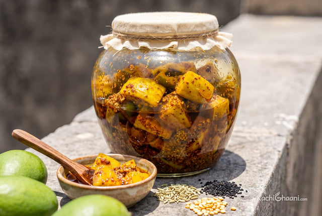 Aam ka Achaar, chunks of bright golden-yellow raw mango coated in coarse red and brown spices