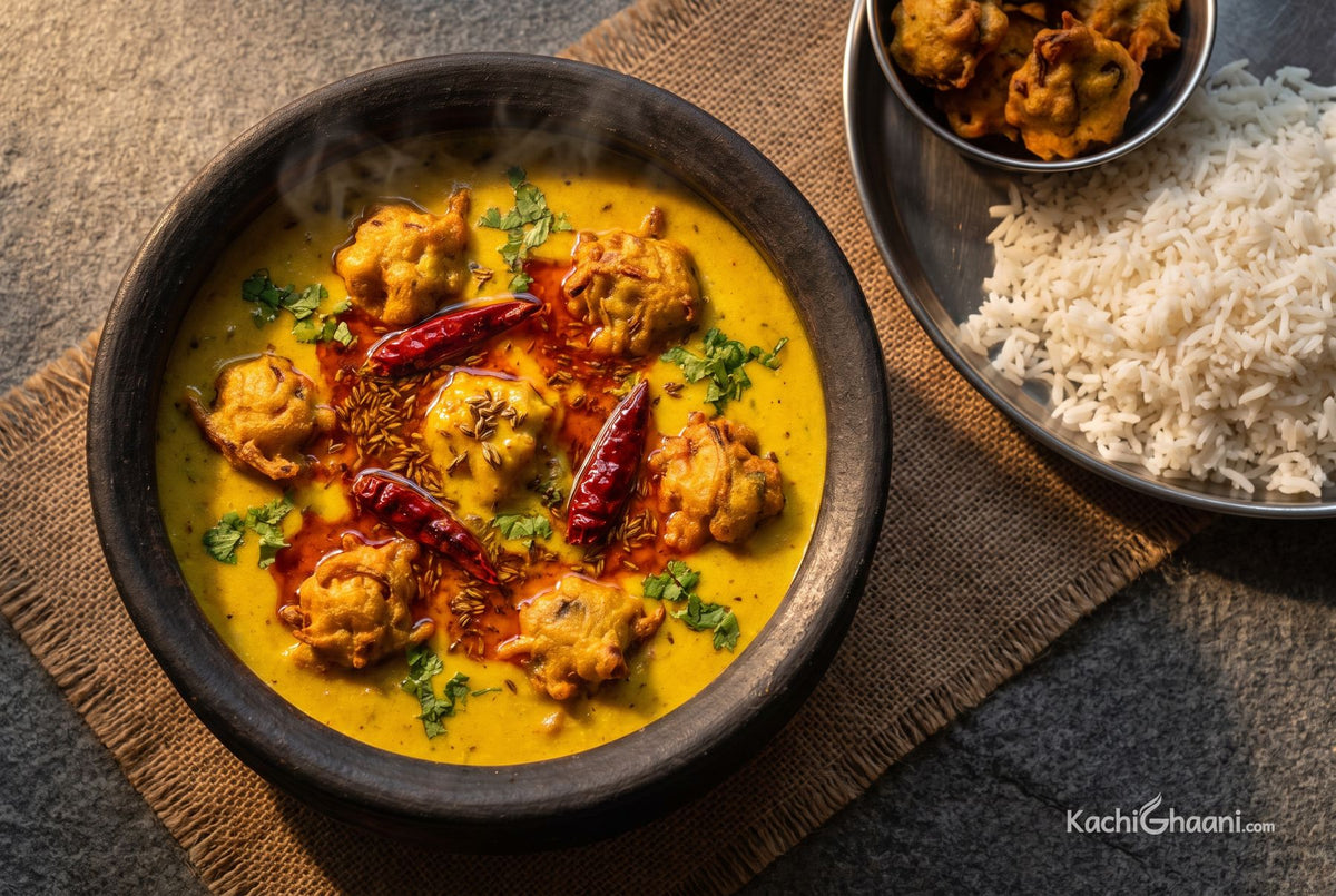 Thick yellow kadhi with onion pakoras and red chilli tadka, served with rice