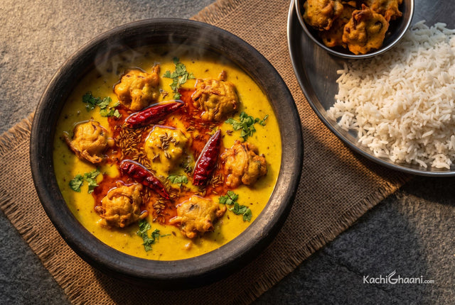 Thick yellow kadhi with onion pakoras and red chilli tadka, served with rice