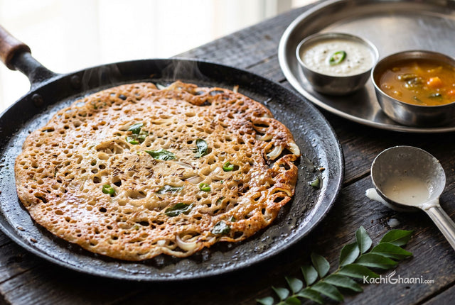 Rava Dosa, a large paper-thin rava dosa on a black iron tawa