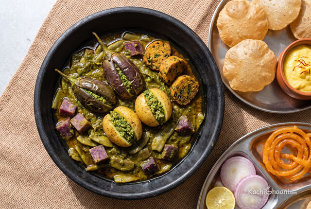 Mixed vegetable undhiyu with stuffed brinjals, yam and muthiya in a clay pot